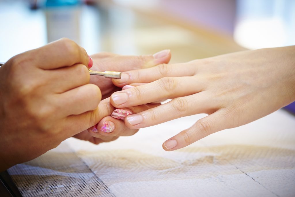 Woman getting a manicure at a nail salon