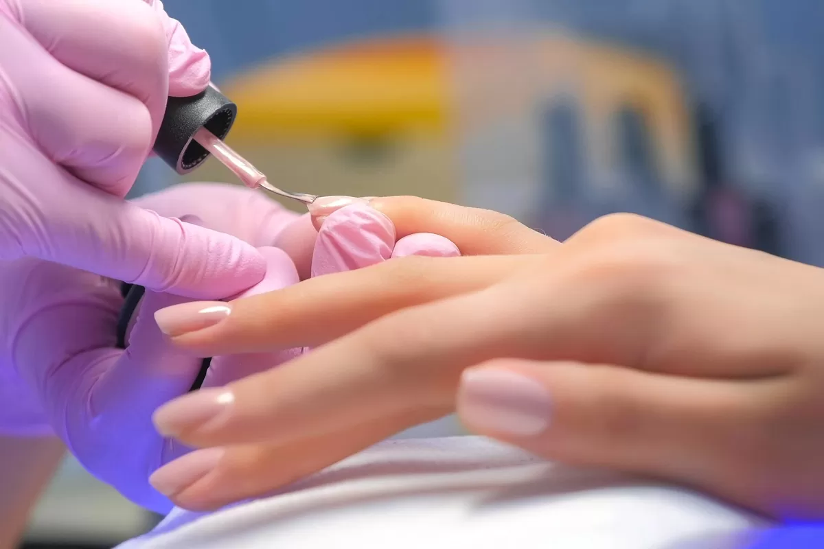 A woman getting her nails done at a nail salon in El Paso.